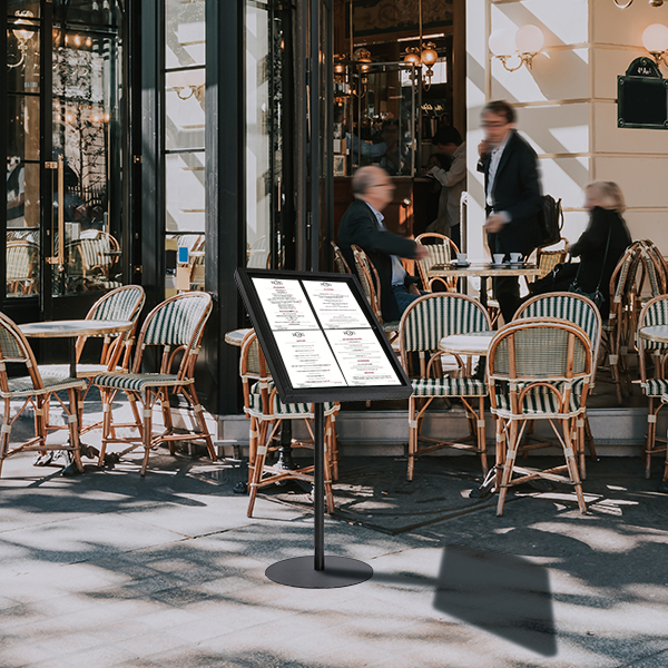 Typical view of the Parisian street with tables of brasserie (cafe) in Paris, France. Architecture and landmarks of Paris. Postcard of Paris